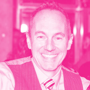 Aaron Davey's headshot with a hot pink filter.
