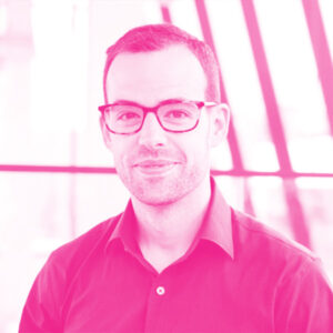 Adam McNamara's headshot with a hot pink filter.