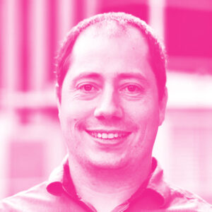 Alex Taylor's headshot with a hot pink filter.