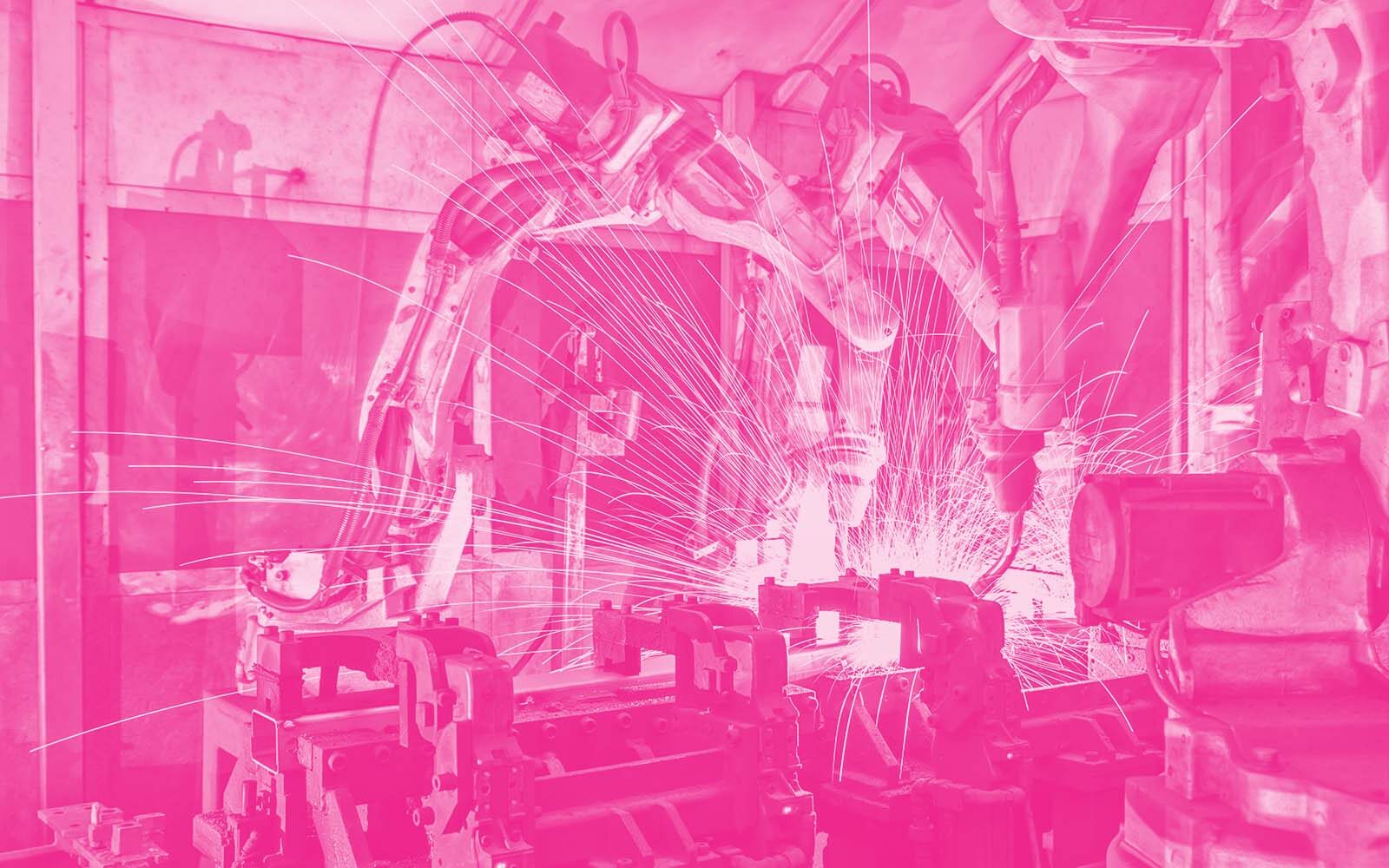 Robotic arms welding on an assembly line.