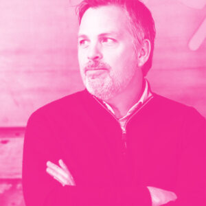 Greg Robinson's headshot with a hot pink filter.