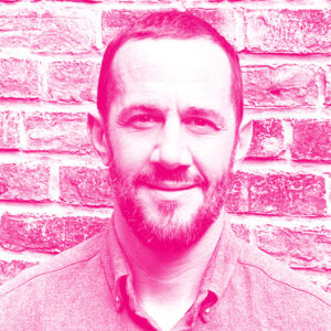 Isaac Souweine's headshot with a hot pink filter.