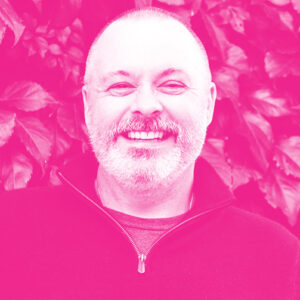Jacques Perreault's headshot with a hot pink filter.