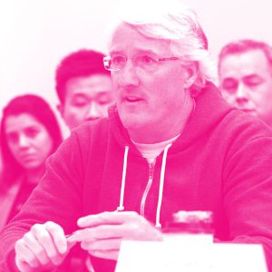 John Francis' headshot with a hot pink filter.