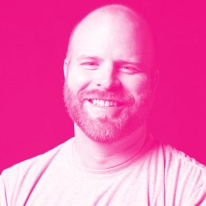 Keith Driver's headshot with a hot pink filter.