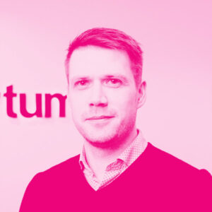 Martin Koppel's headshot with a hot pink filter.