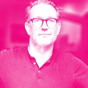 Richard Titus' headshot with a hot pink filter.