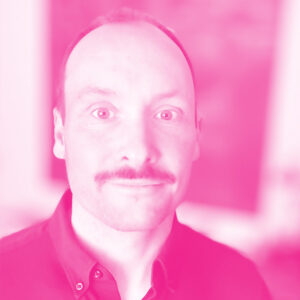 Simon Betschel's headshot with a hot pink filter.