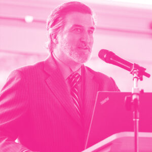 Toby Stapleton's headshot with a hot pink filter.