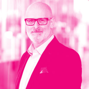 Troy Dale's headshot with a hot pink filter.